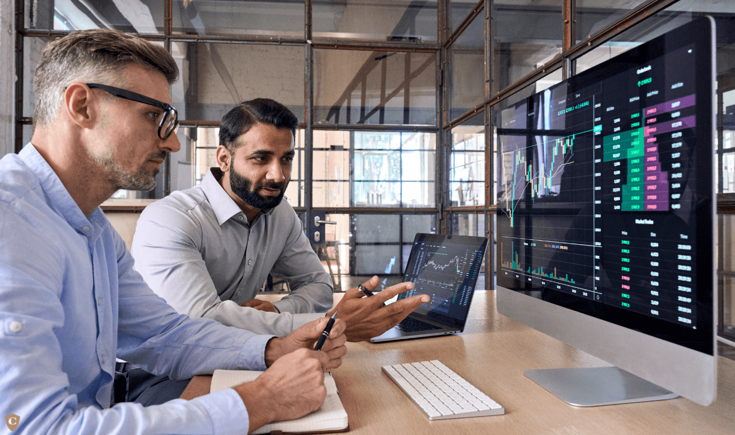 Two men discuss financial trading charts - Onchain Trading