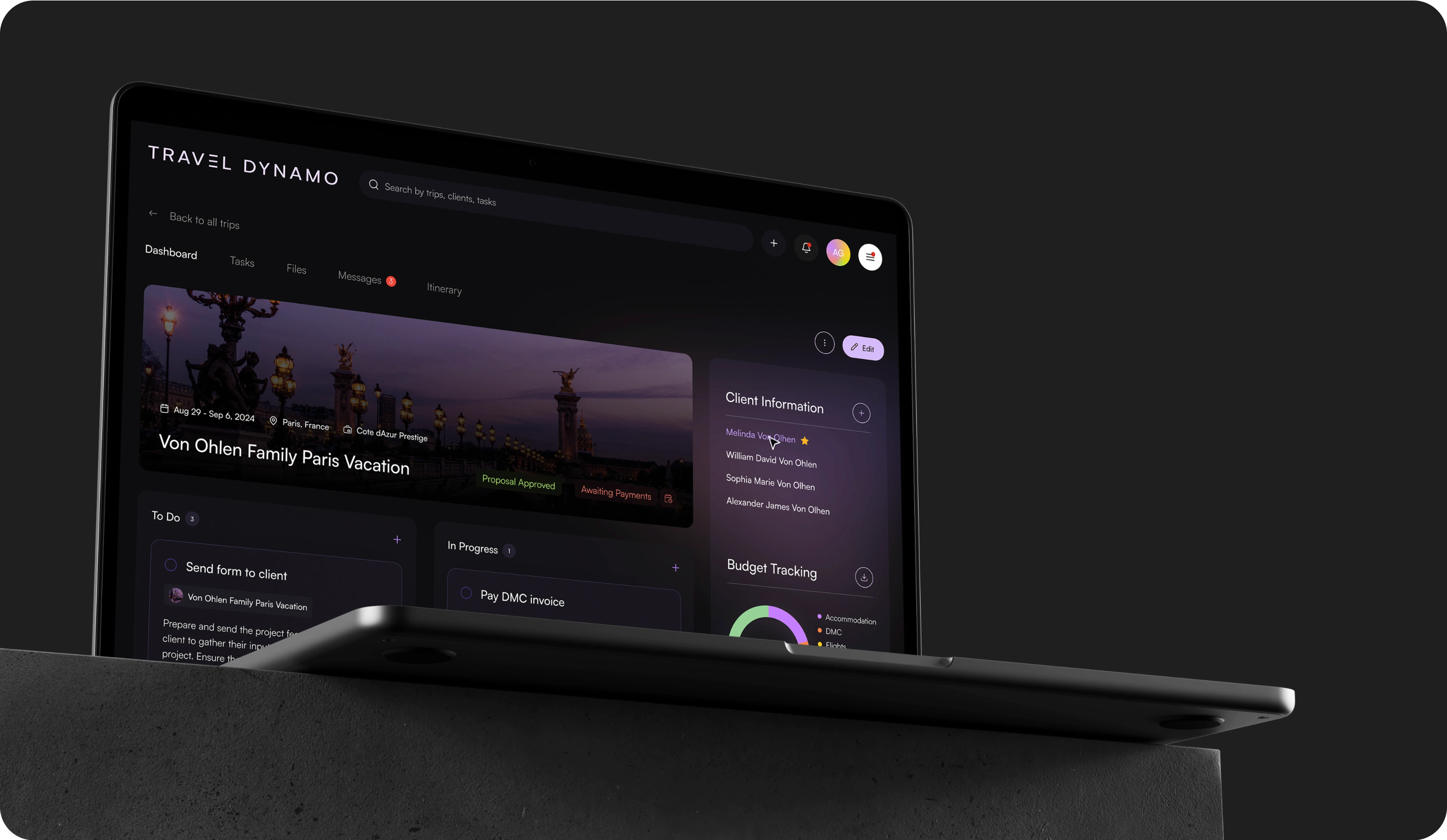 Image of a laptop displaying the 'Travel Dynamo' travel management software on a dark, textured surface. The screen shows a user dashboard for the 'Von Ohlen Family Paris Vacation' with various panels including tasks, files, messages, and itinerary. The dashboard is well-organized, featuring sections like 'Client Information', 'Budget Tracking', and a to-do list with tasks like 'Send form to client' and 'Pay DMC invoice'. The UI is sleek with a dark theme and purple accents, enhancing the visual appeal and readability.