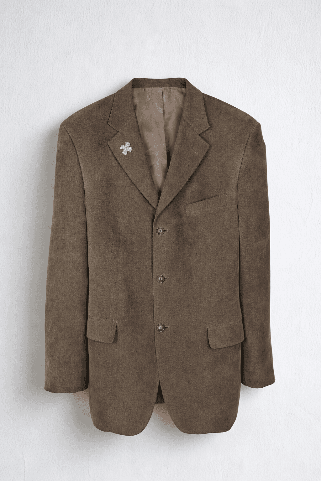 Brown blazer with gold buttons and lapel pin