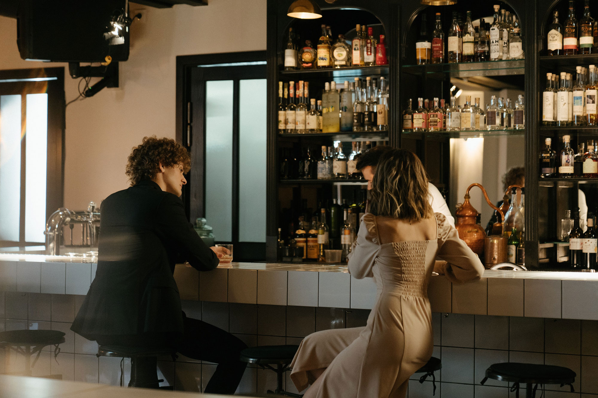 A man and a woman sitting at a bar