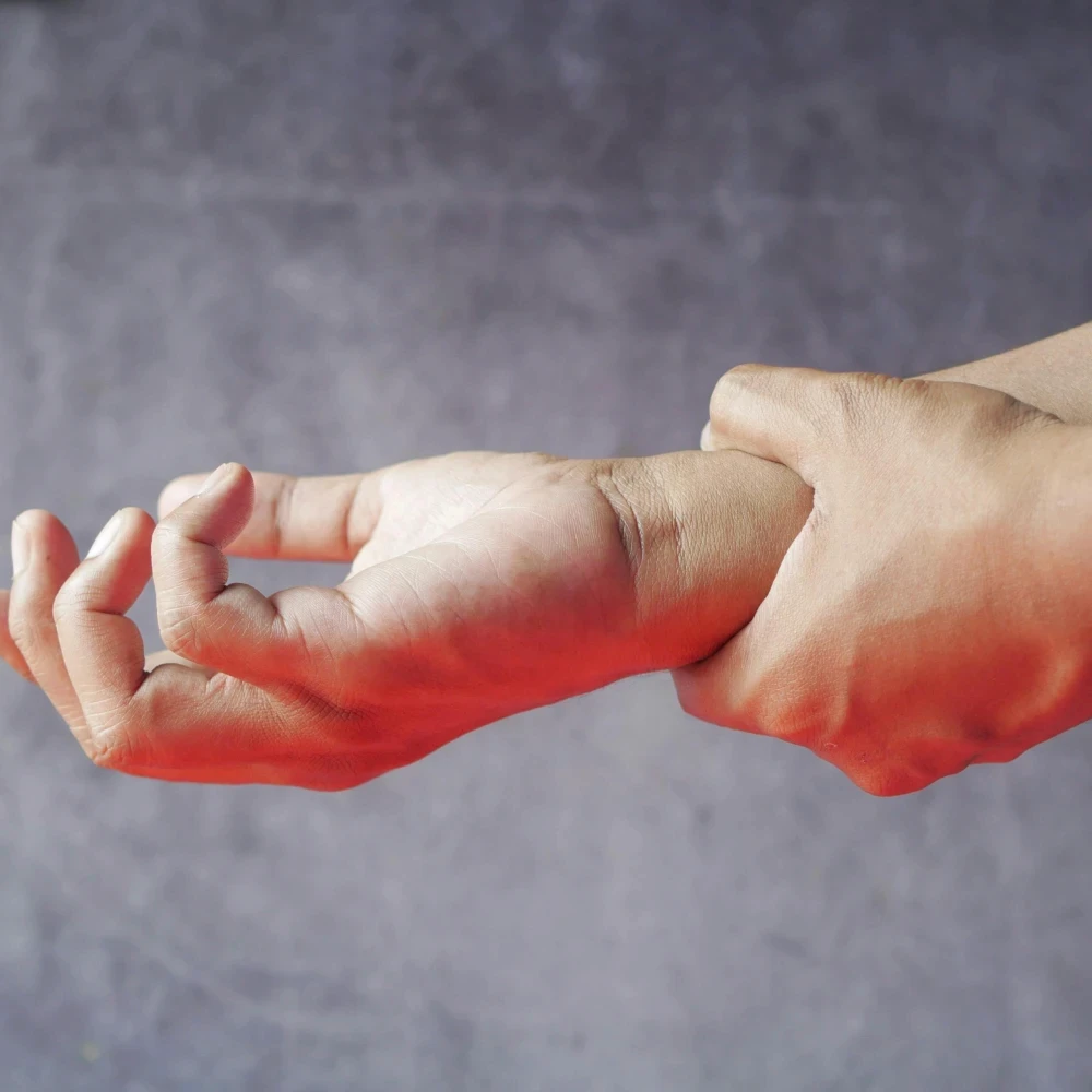 A woman holding her wrist in pain