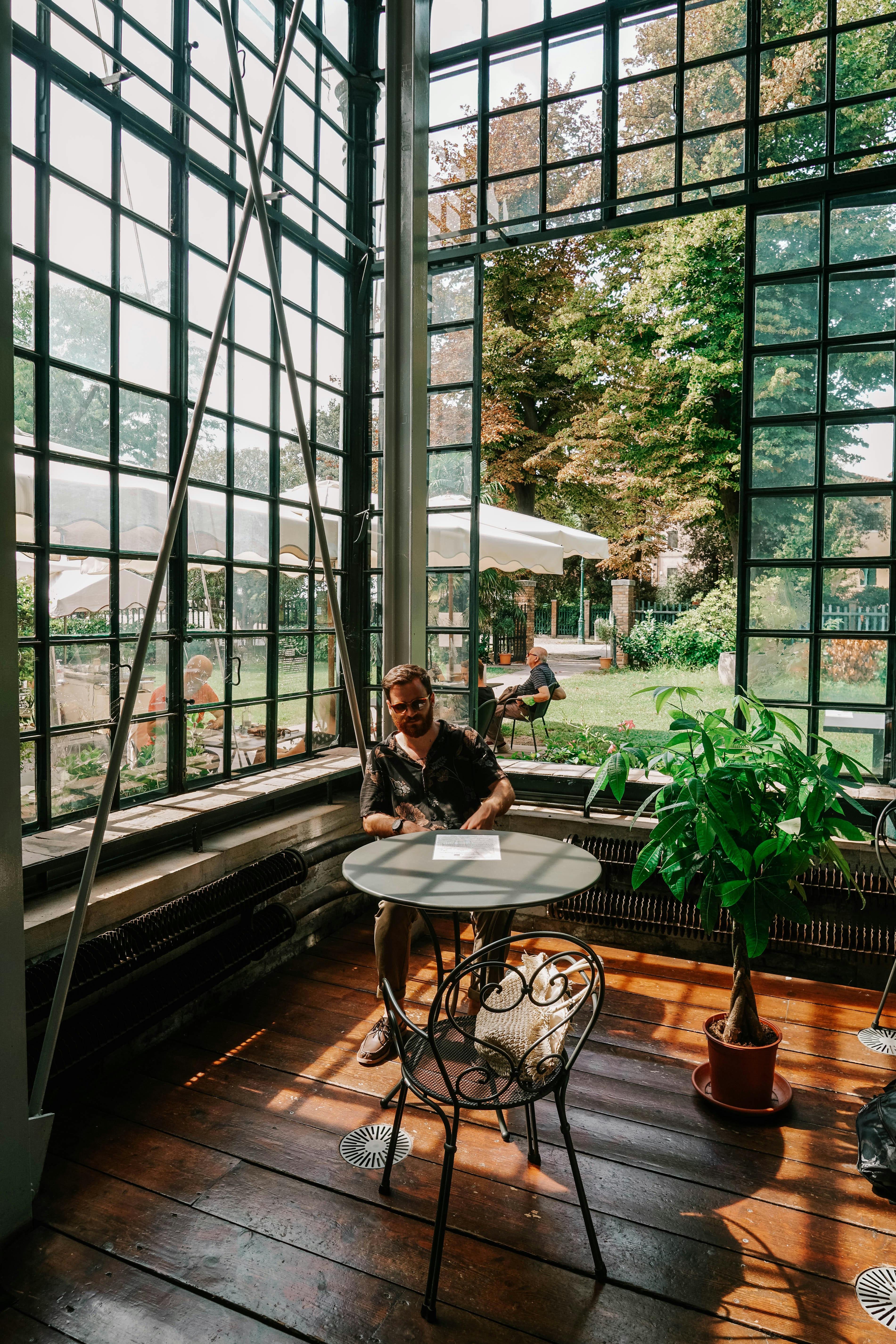 woman in black shirt sitting on brown chair