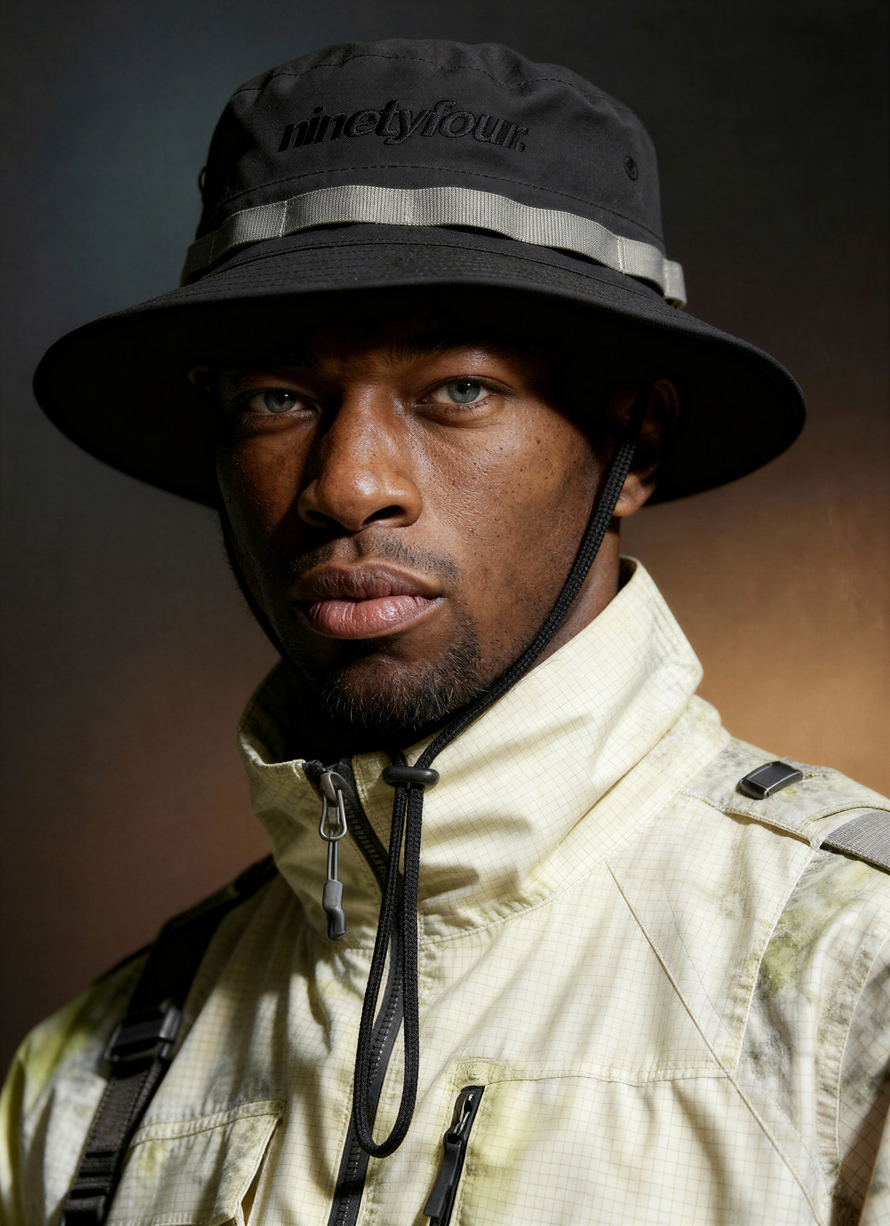 Black cosmetic jar with metallic silver cap on white