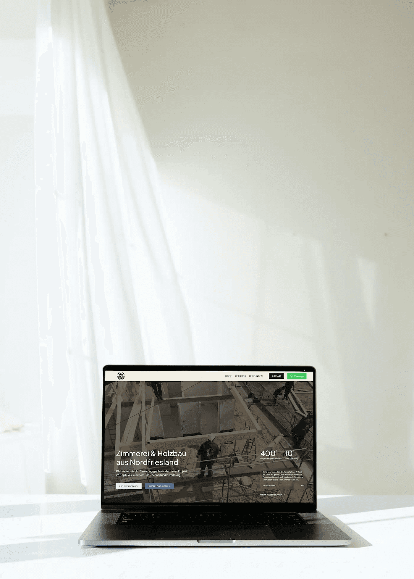 Ein Laptop steht auf einem Tisch der ein Wireframe für eine Website baut
