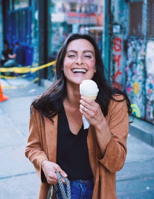Woman smiling while eating icecream