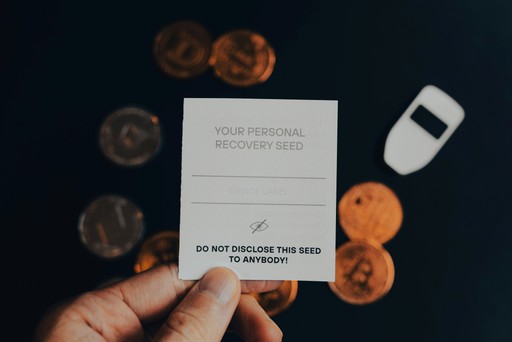 a person holding a business card in front of a pile of coins, illustrating a security deposit