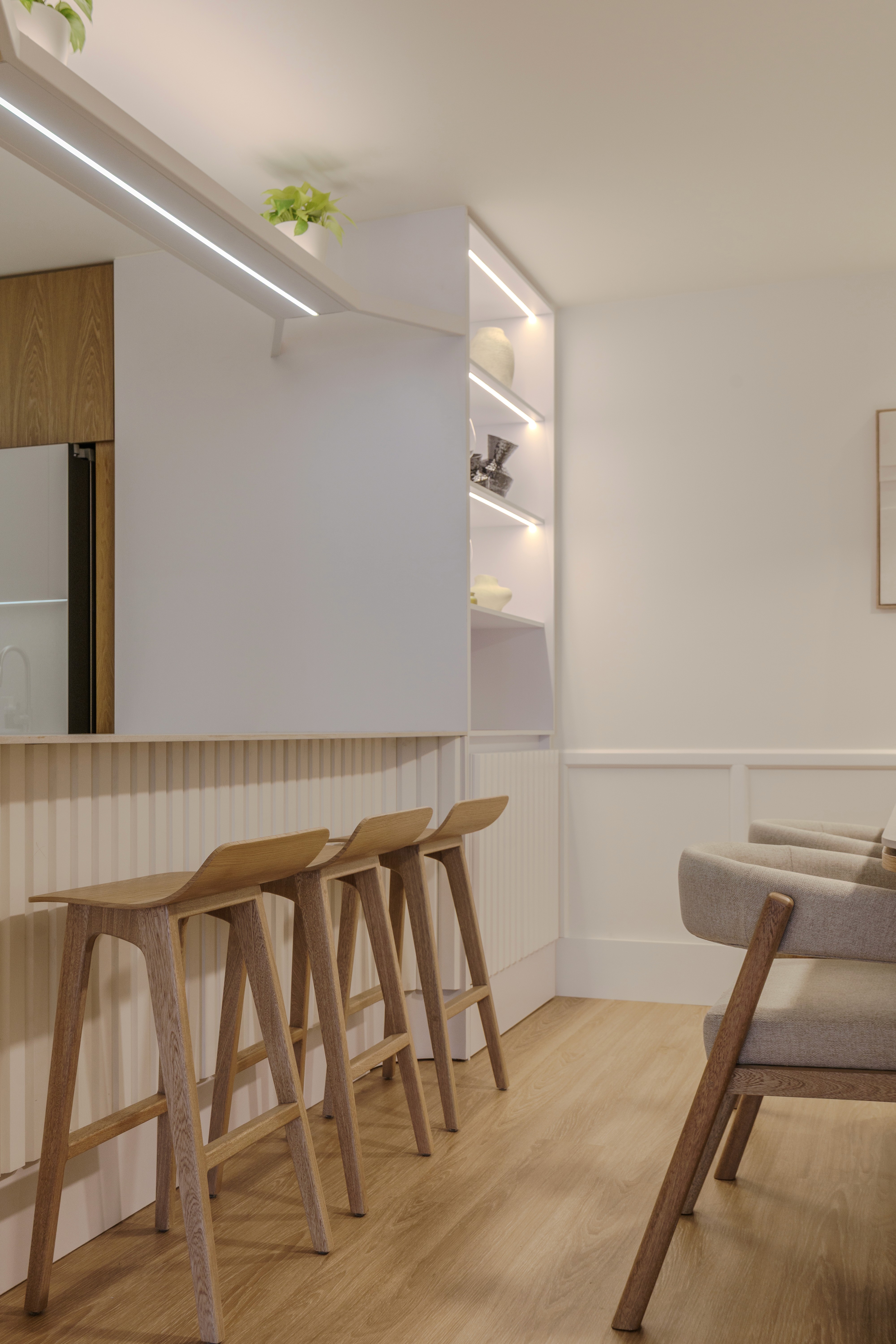 Double-height interior with flowing sculptural forms and warm raking light