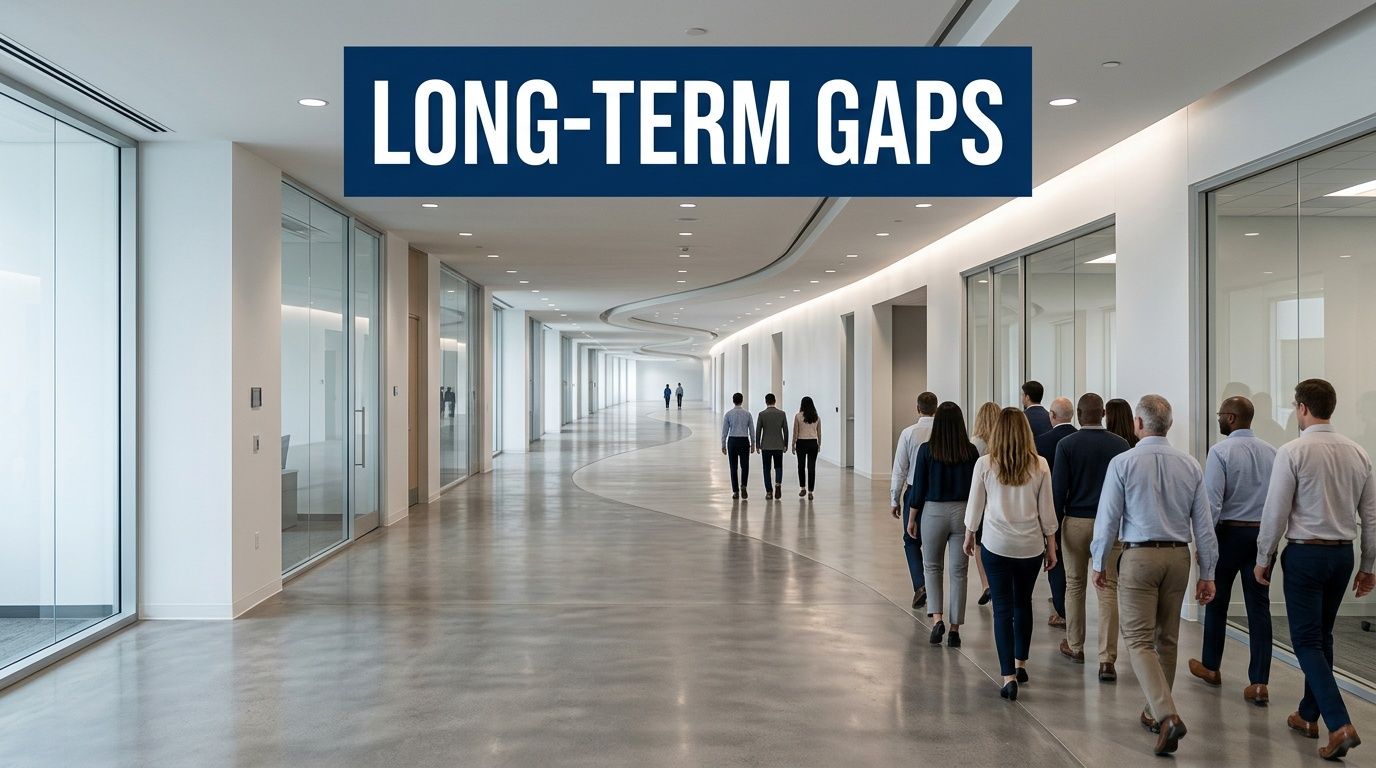 A diverse group of professionals walking down a modern, spacious office hallway toward the exit.