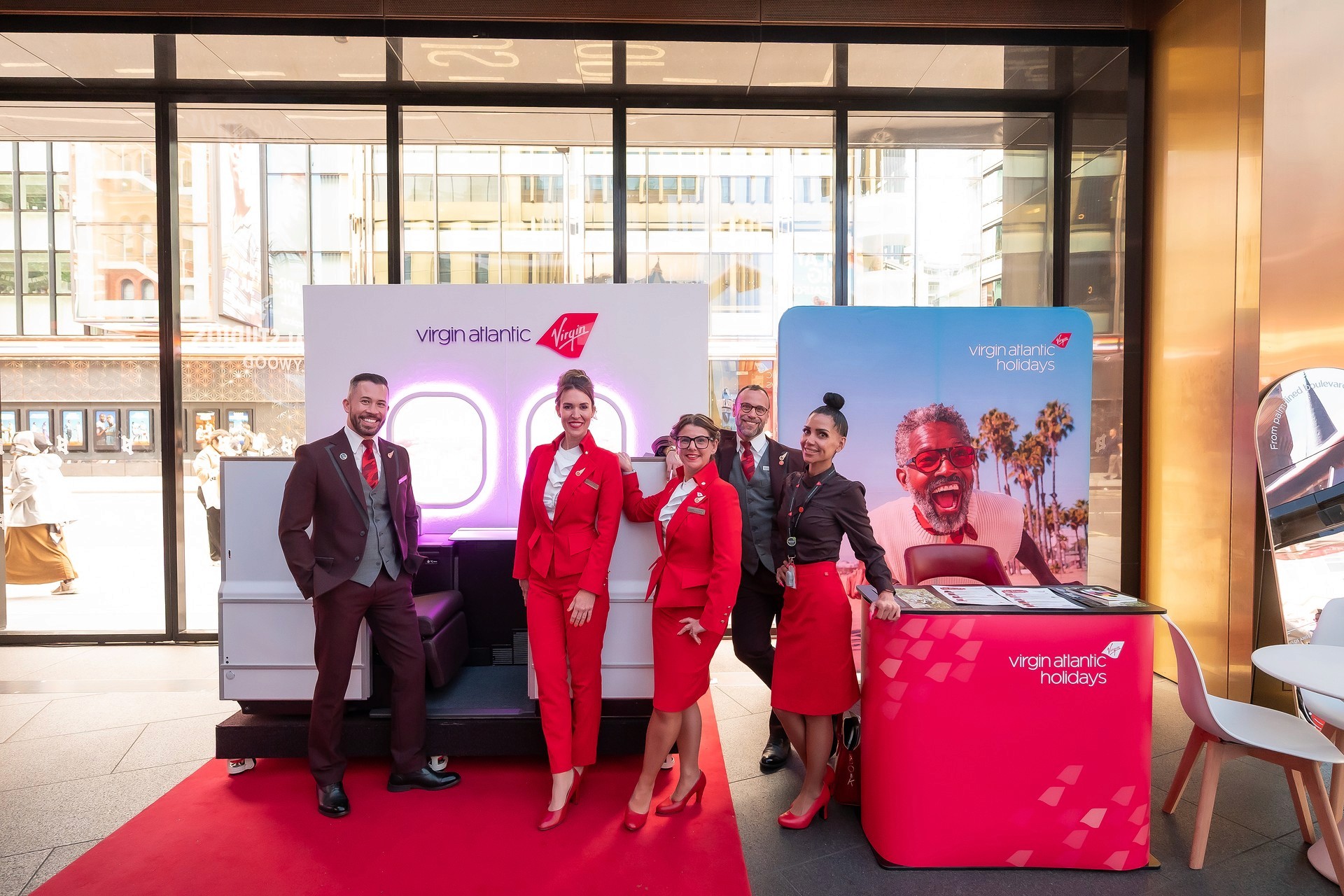 Virgin Atlantic Holidays activation for Visit California at Outernet London, featuring branded scenic elements, red carpet, airline cabin props and event staff.