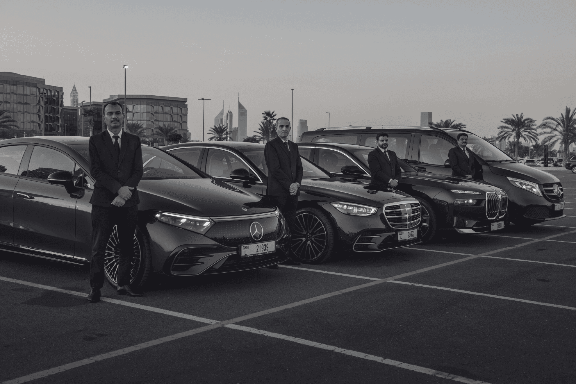 Chauffeurs standing beside their fleet