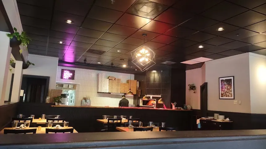 three people sitting in front of table laughing together