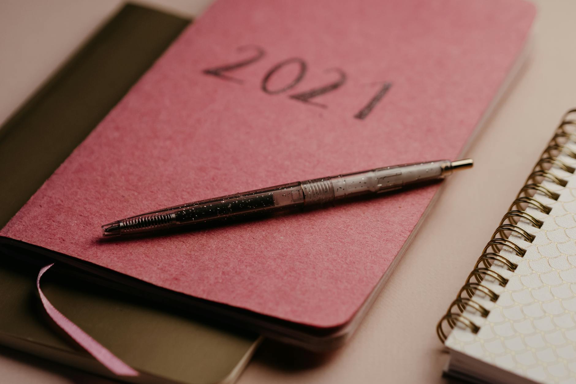 Close-up of a notebook with camp notes and contact information next to football cleats