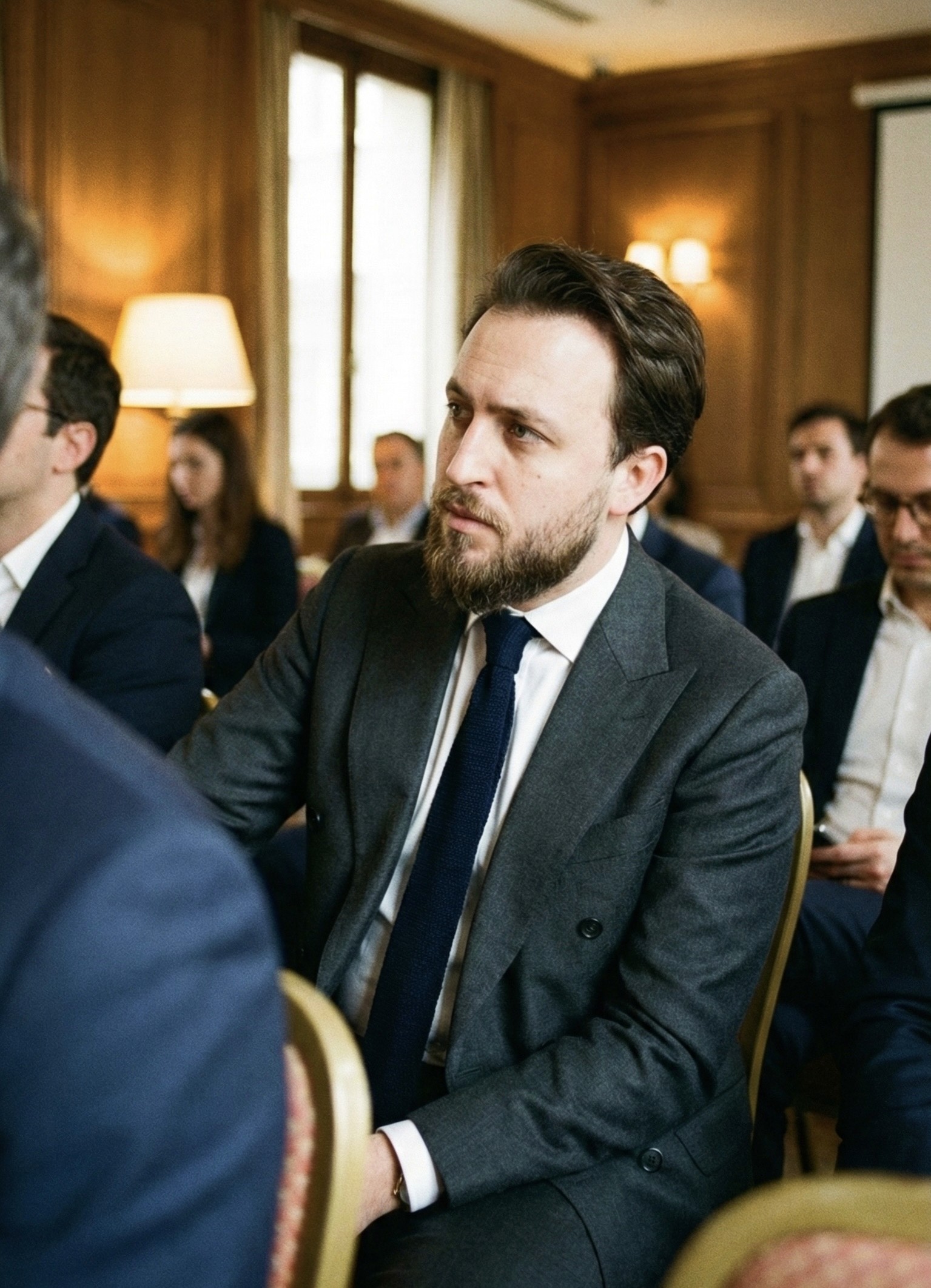 person sitting on grass and using phone