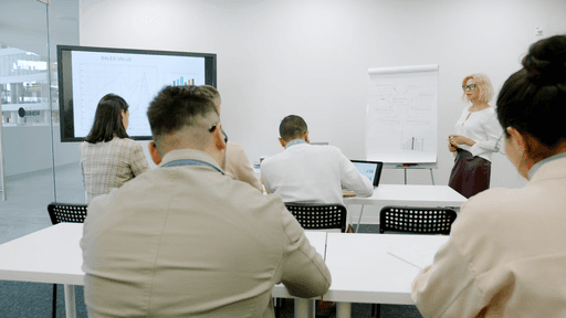 Instructor giving a presentation to a group of students in a classroom setting.