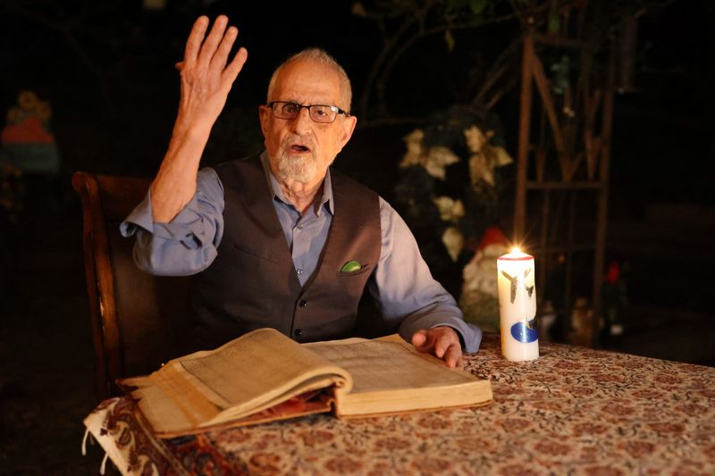 Bubjan with book and speaking to camera