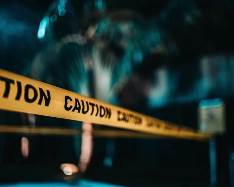a no entry site with the words "caution" written on the bands
