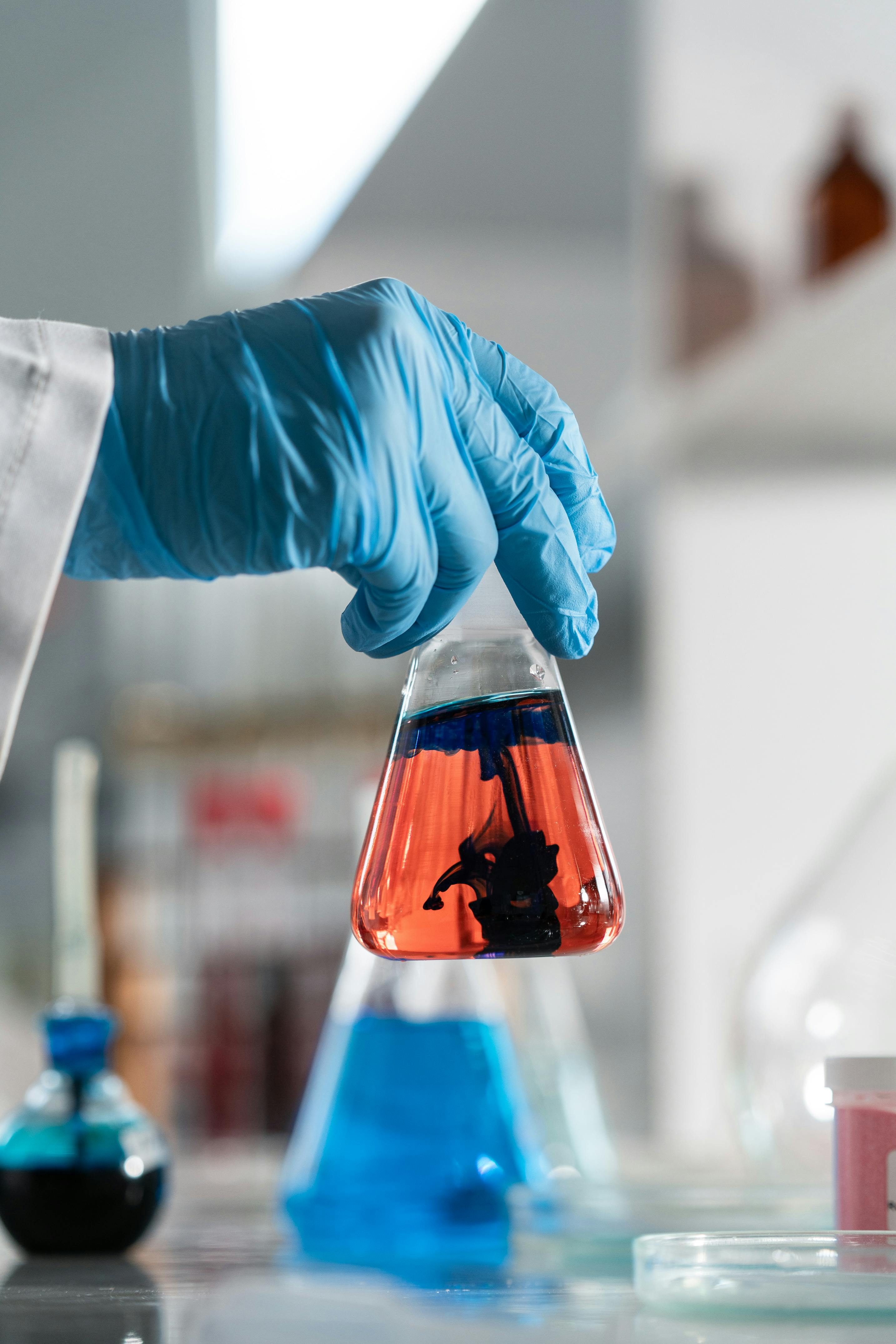A woman in a straw hat stands in the grass