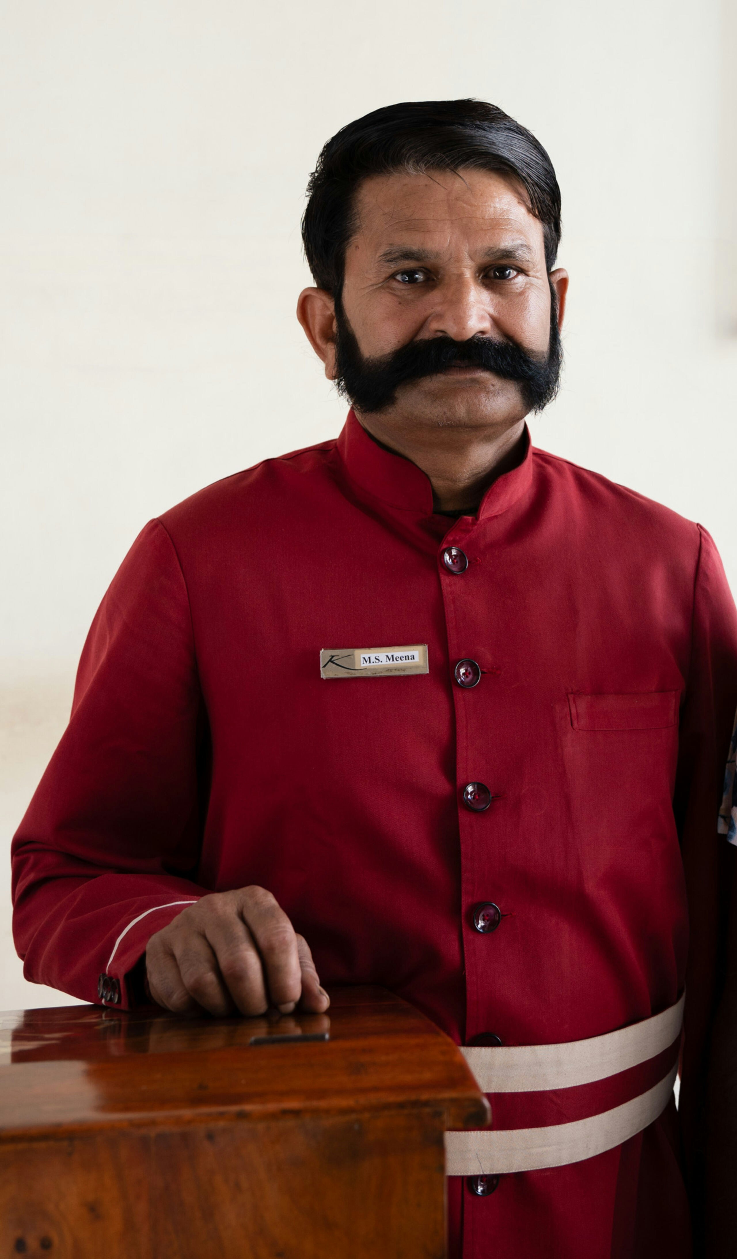 A man with a mustache standing next to a woman