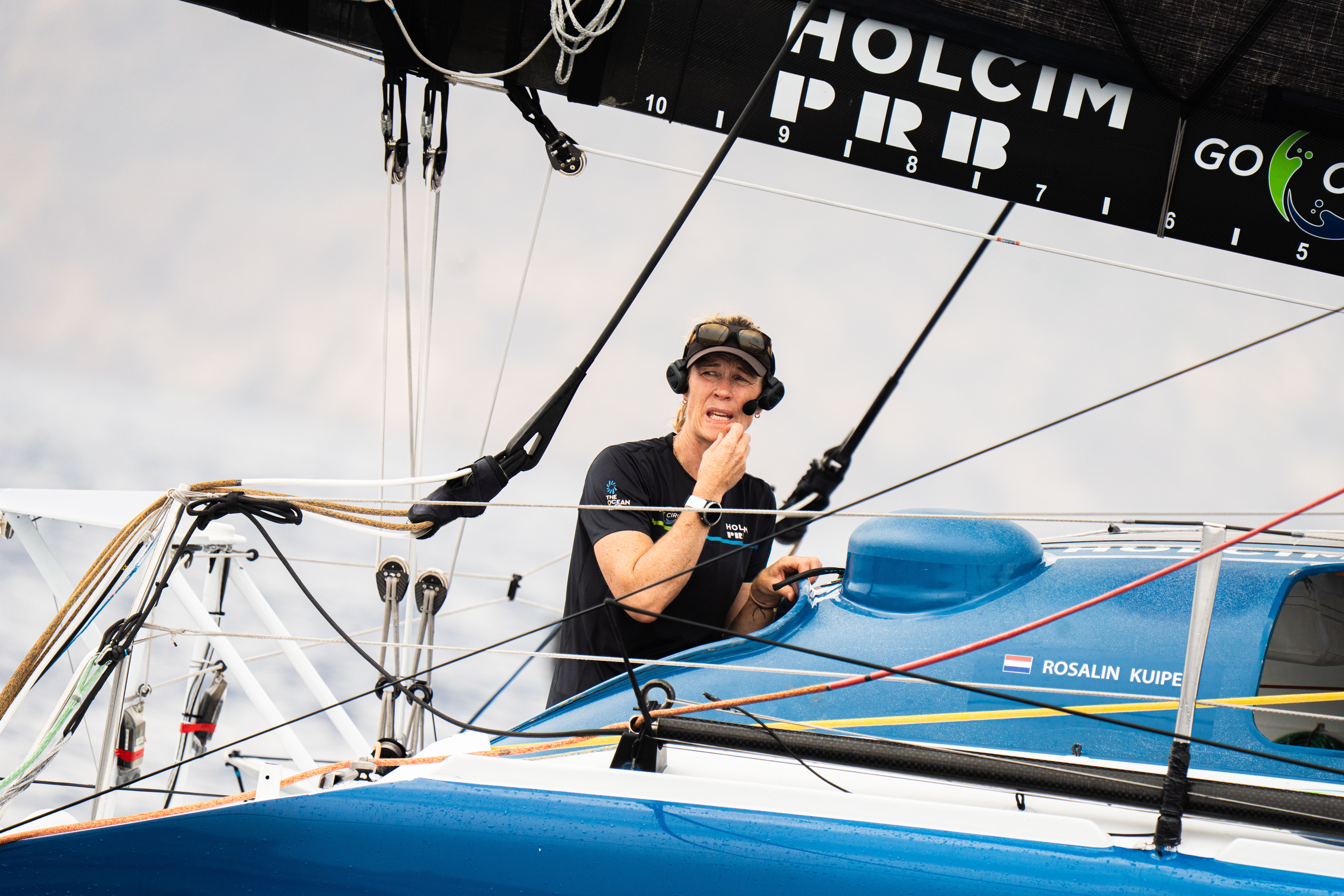  A woman in a helmet with a light trail, suggesting movement or speed in a dynamic outdoor setting.