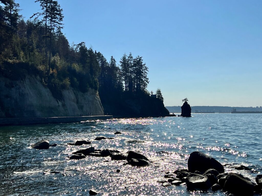 Along Vancouver's Seawall walk with the Siwash Rock in the waters.