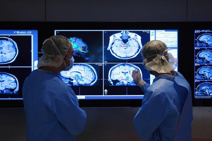 Two doctors looking at the scan of Patient