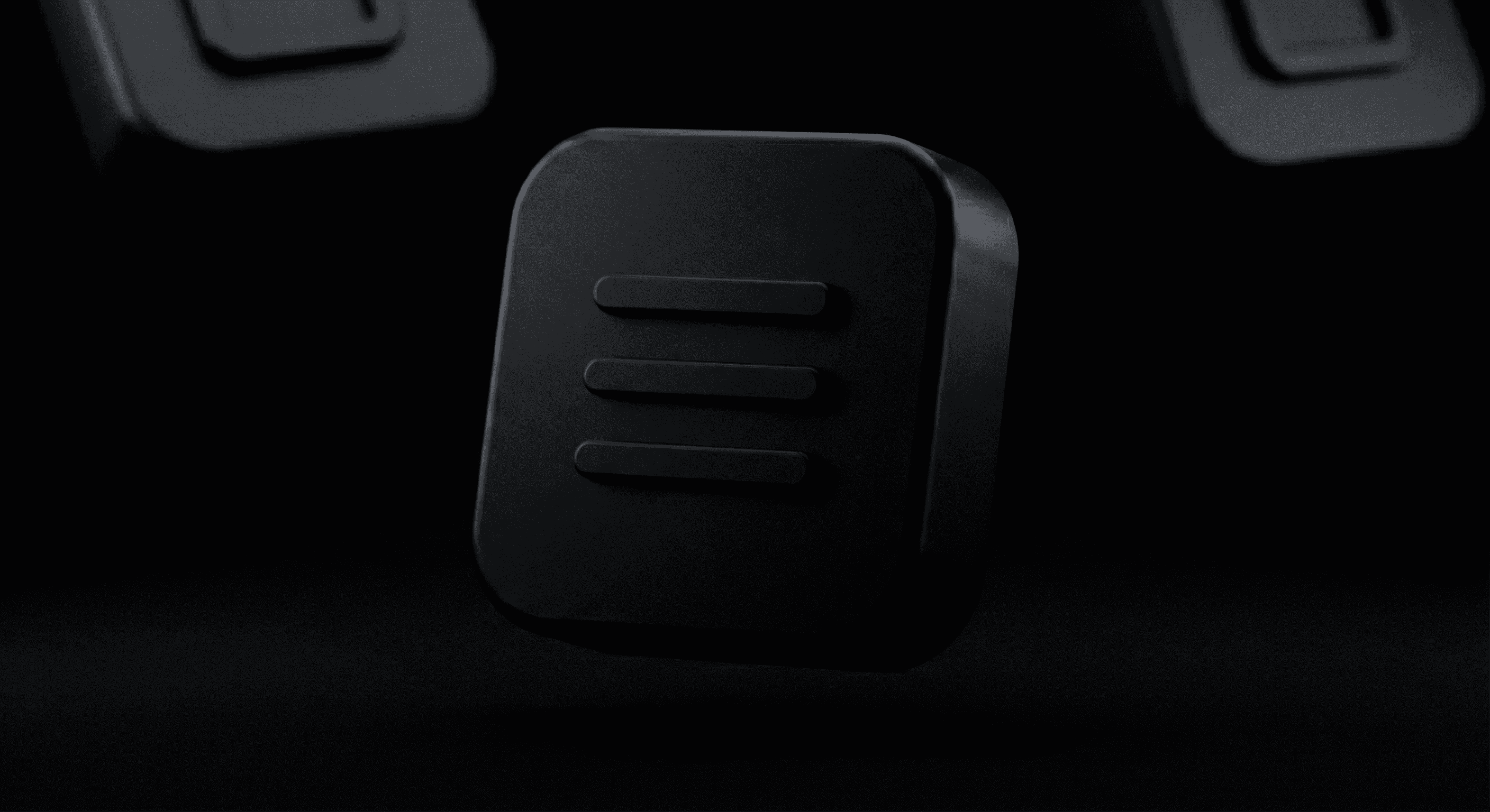 a close up of a black object with a black background