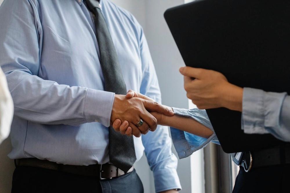 Personas estrechando la mano tras un acuerdo, representando inversión conjunta a través de una sociedad en Chile