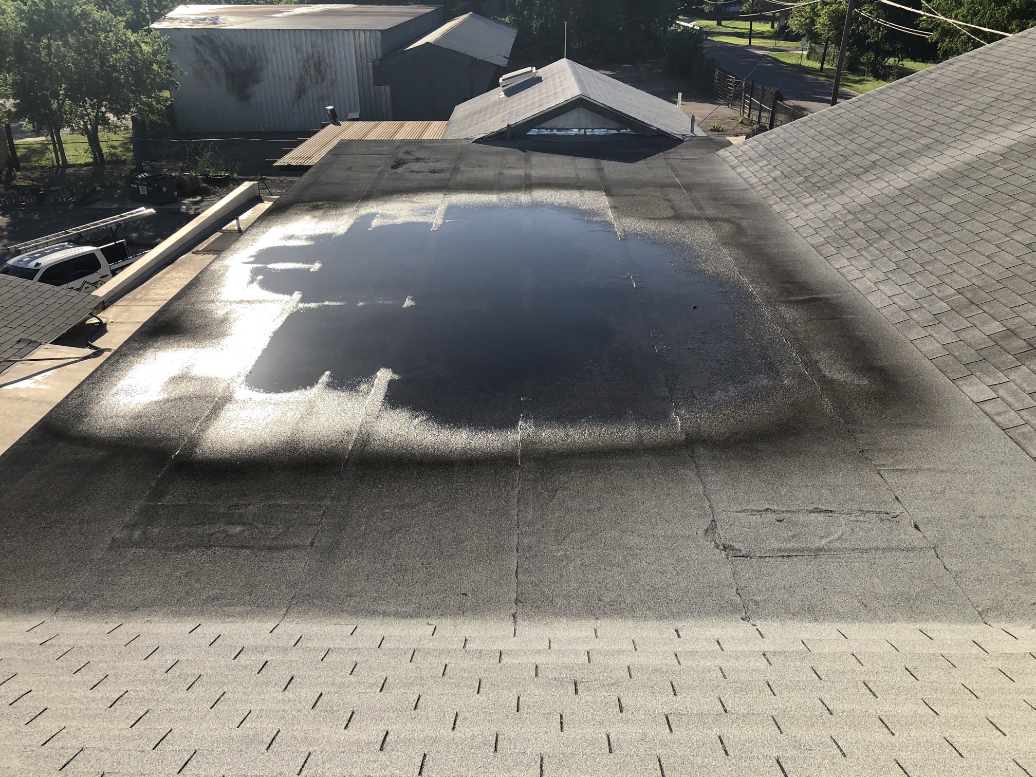 Ponding water of a flat roof in Austin Texas. 