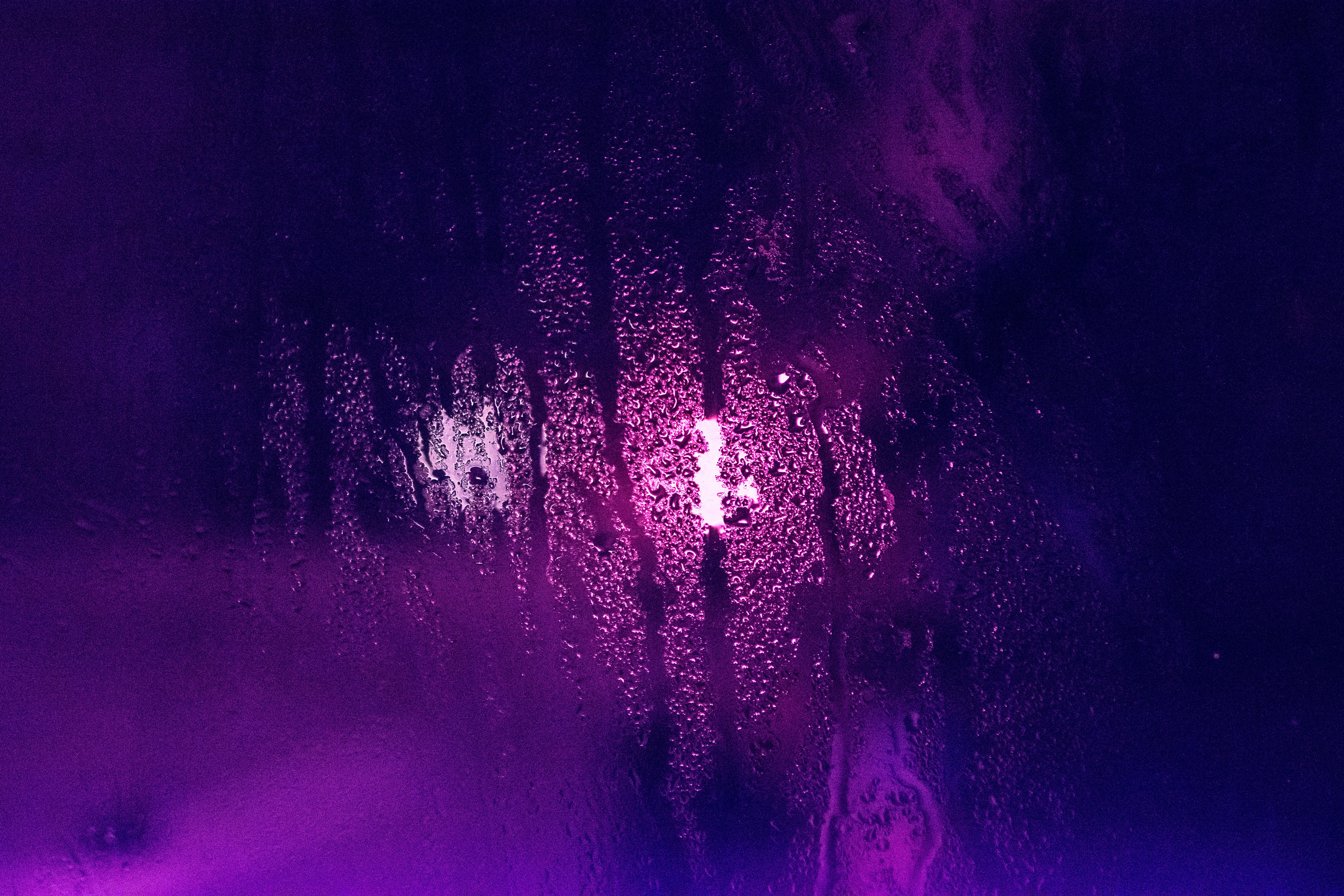 a close up of a window with a purple light