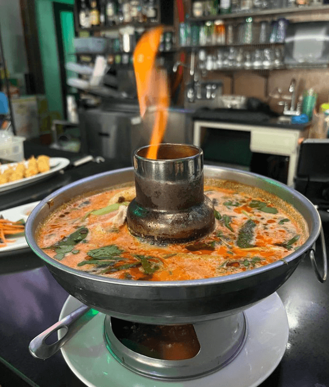 Tall, open restaurant venue with wood tables and chairs