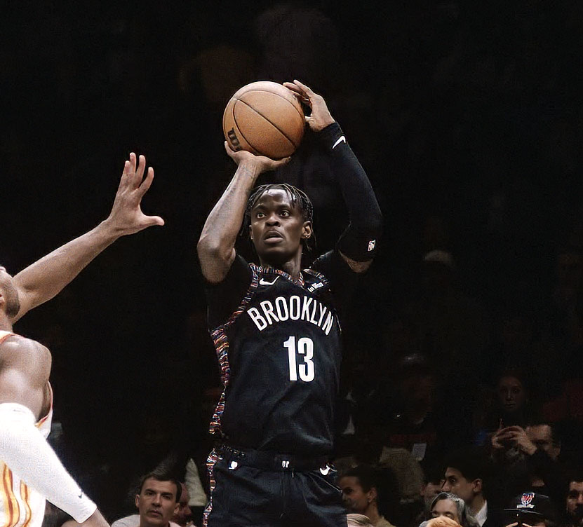 Tre Scott wearing jersey number 13 jumps to take a shot, holding the ball above his head, while a defender in a white jersey tries to block him during a game.