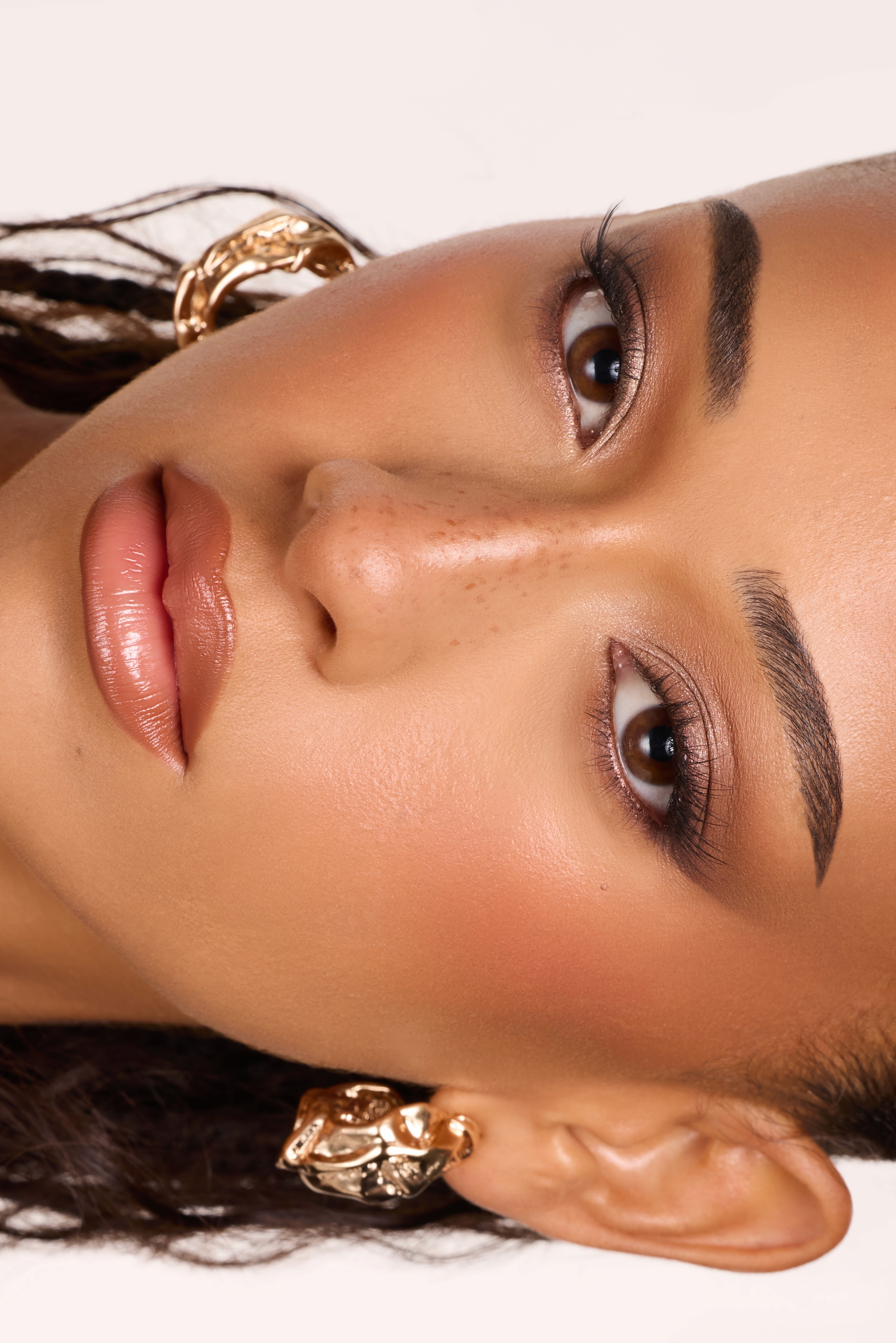 close up beauty image of woman with soft glam clean makeup in clean bright lighting