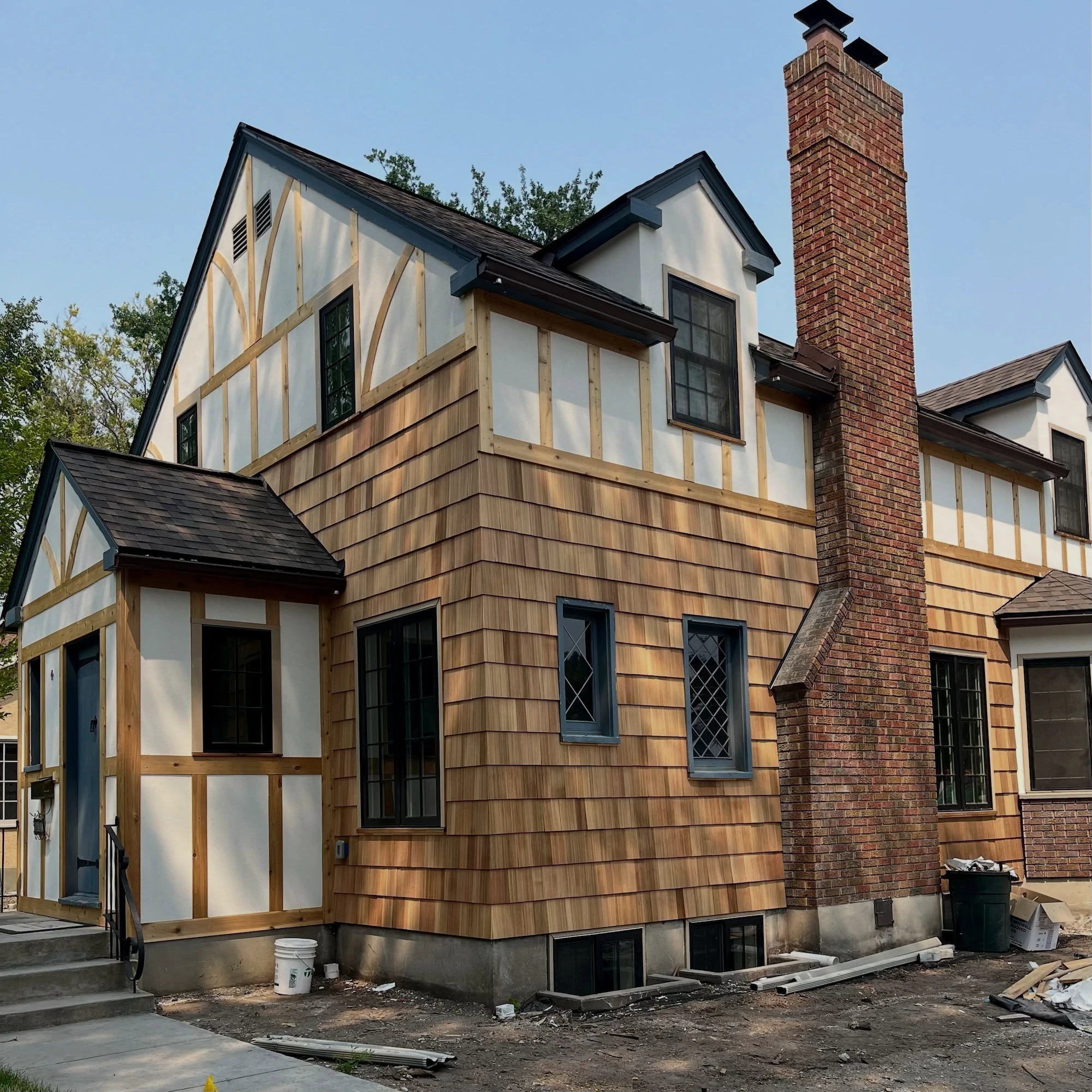House exterior finished with cedar shingles and black-trimmed windows