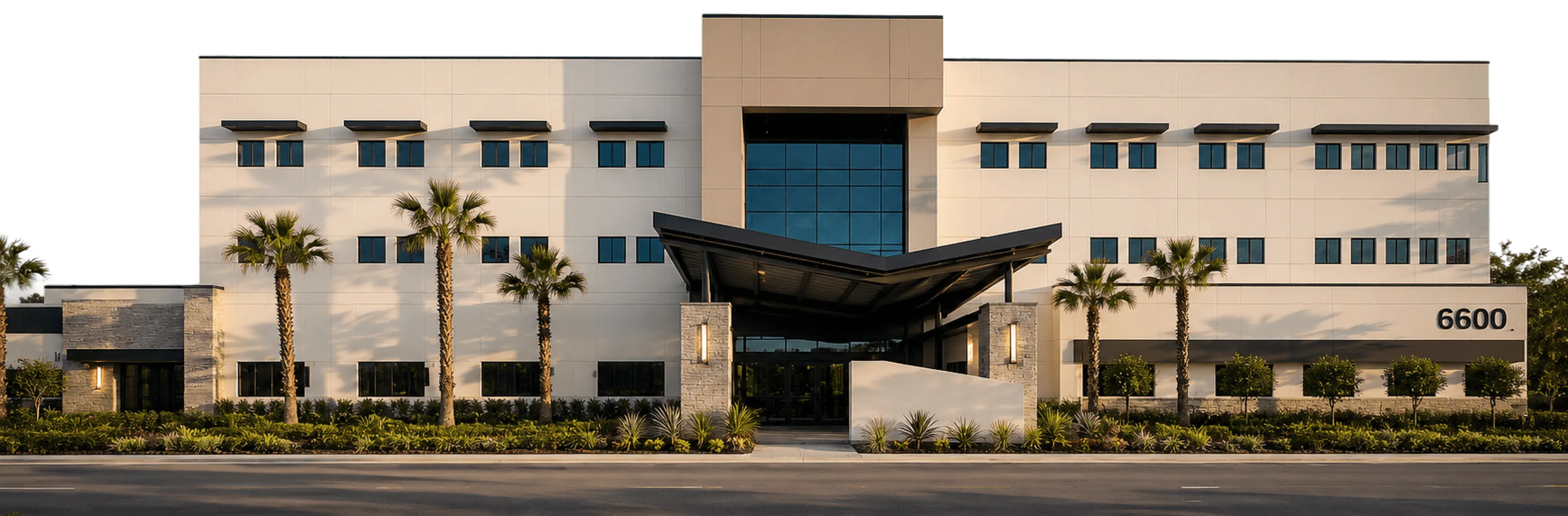 Modern office building with palm trees.