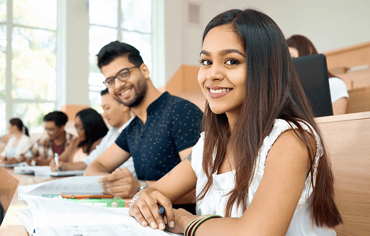 Exchange student working on academic research in a university library abroad