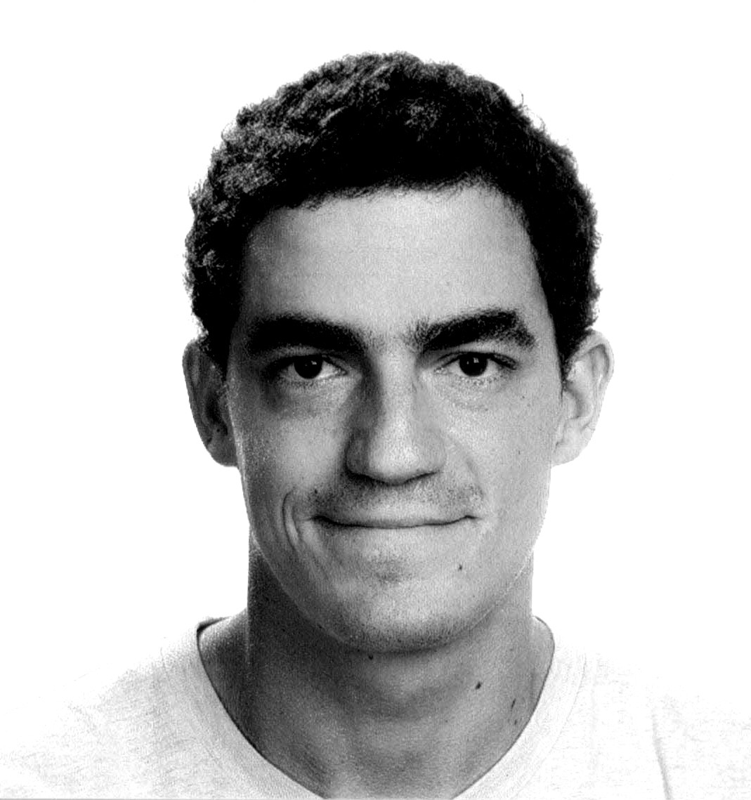 A smiling woman writing on a piece of paper in her home