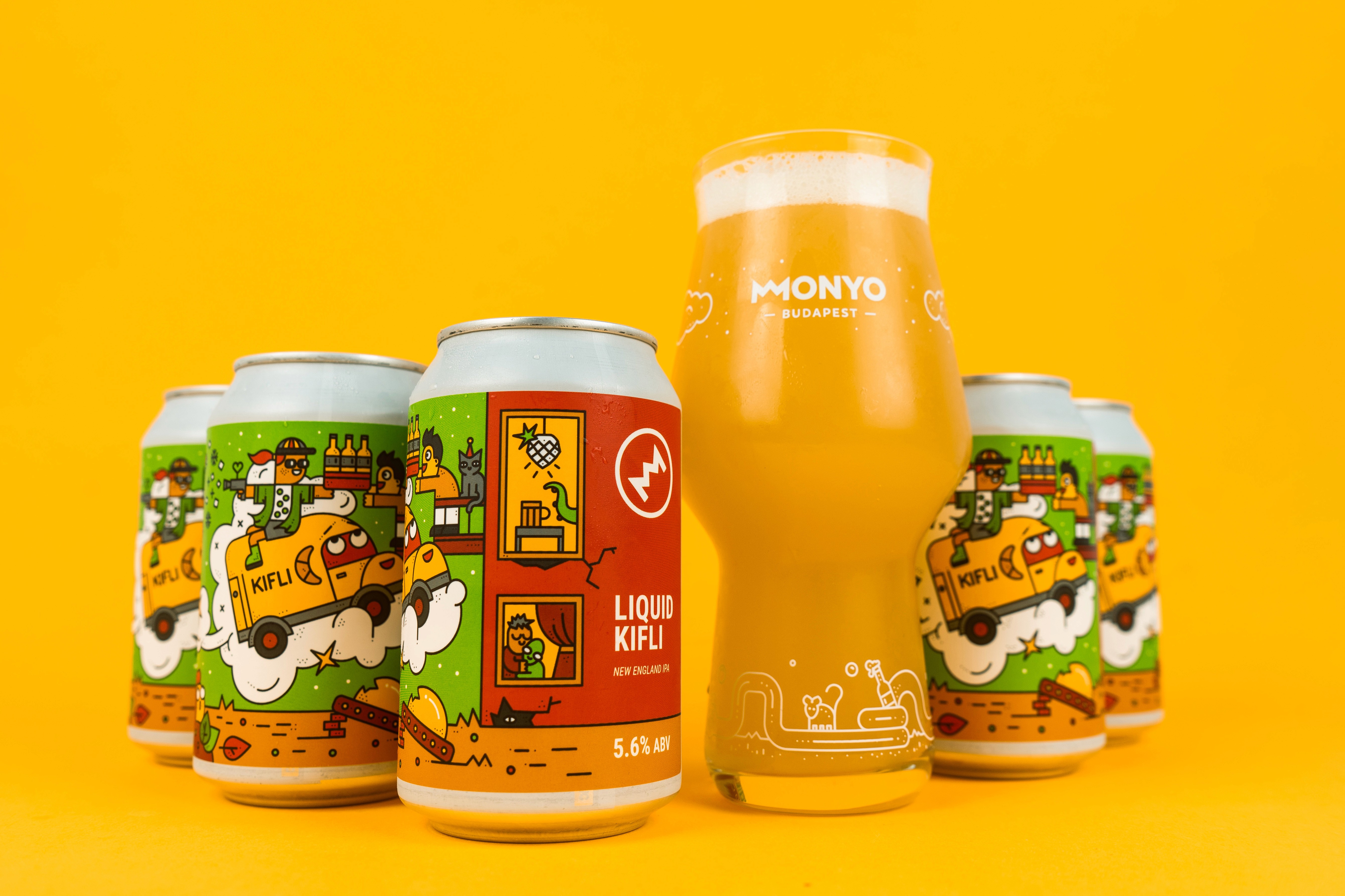 Woman in blue hat and sweater sitting on couch with laptop.