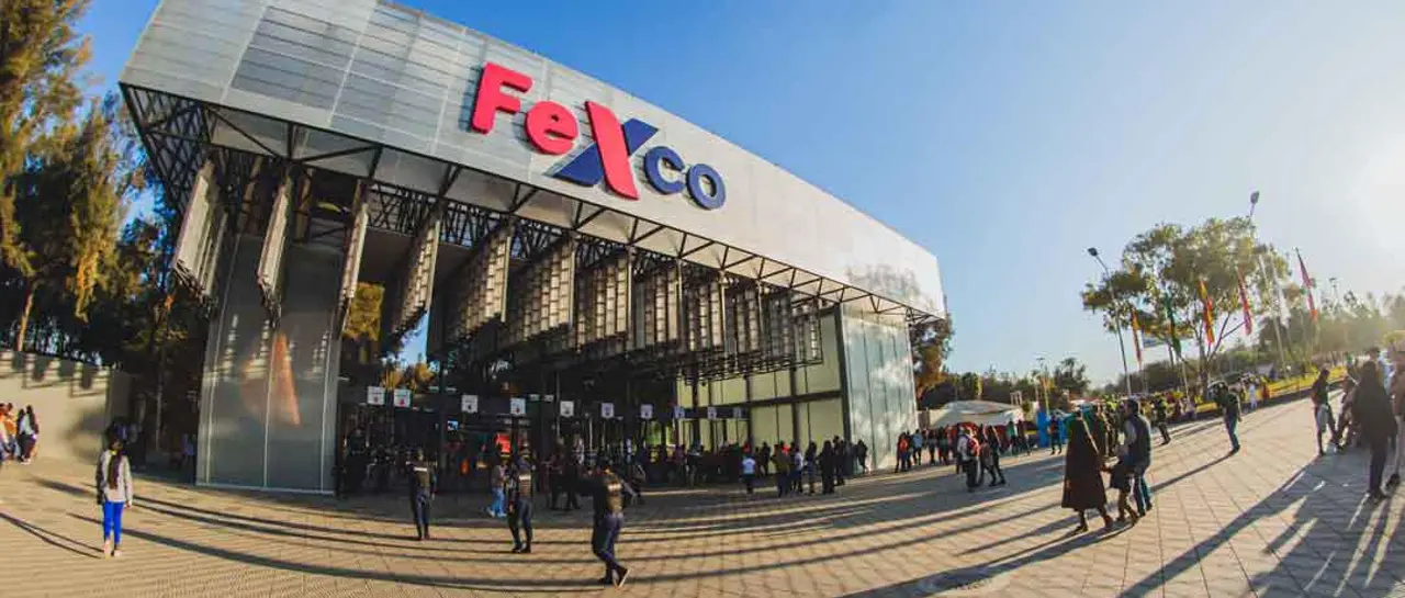 Young man in black leather double-breasted jacket jeans looking at the bottom