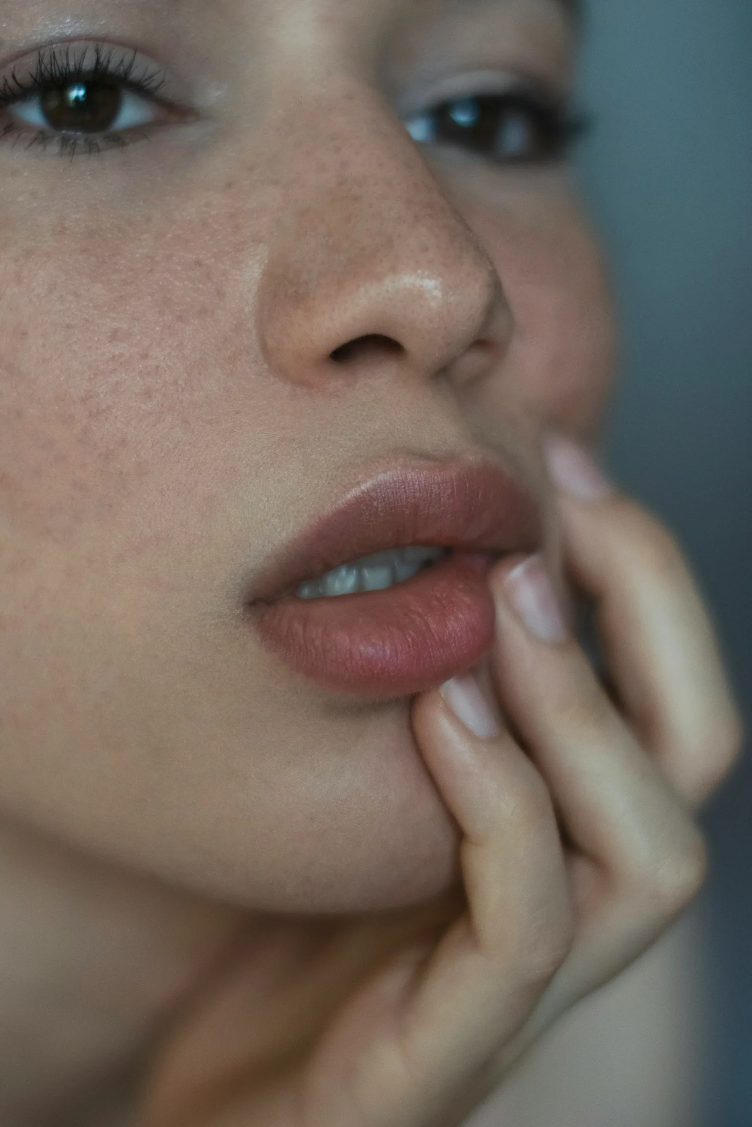 A woman resting her fingers on her lips