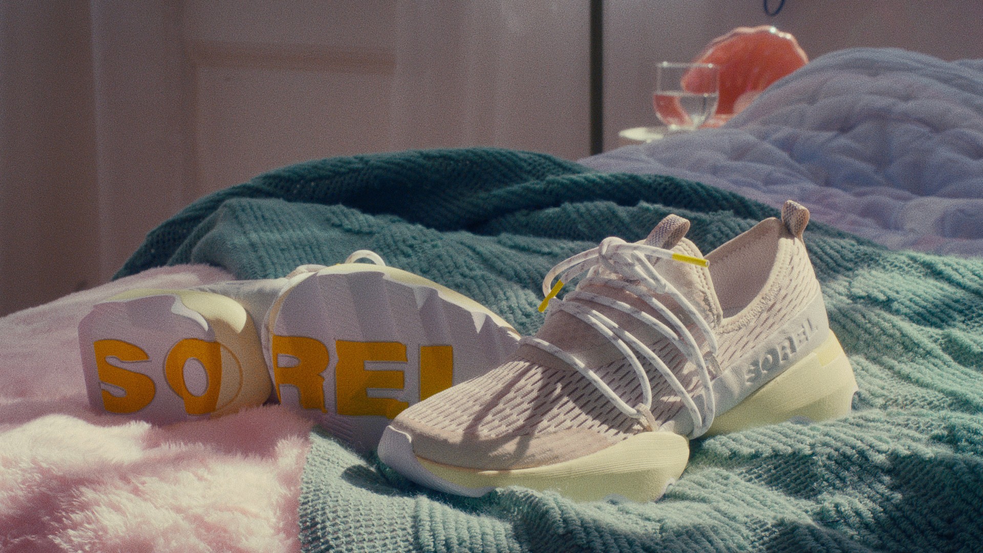 Cool close-up of Sorel sneakers on a stylized bed