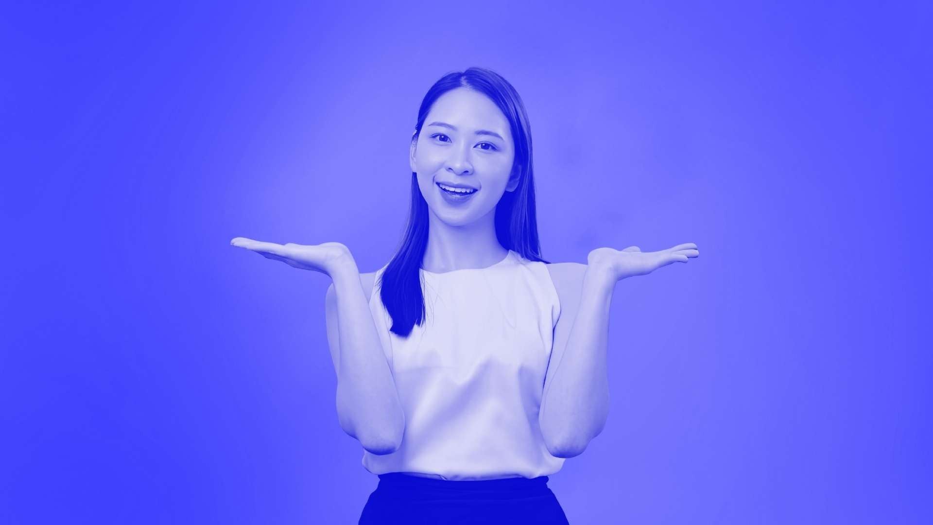 A woman holding both hands up