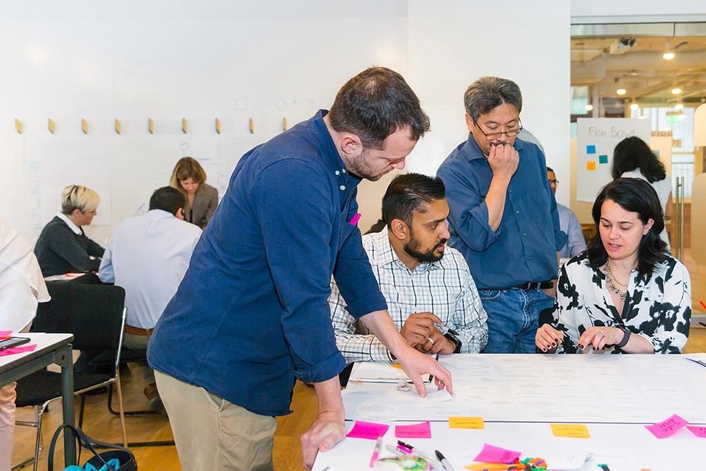 A candid of a cross-functional team at work, navigating shared constraints together.