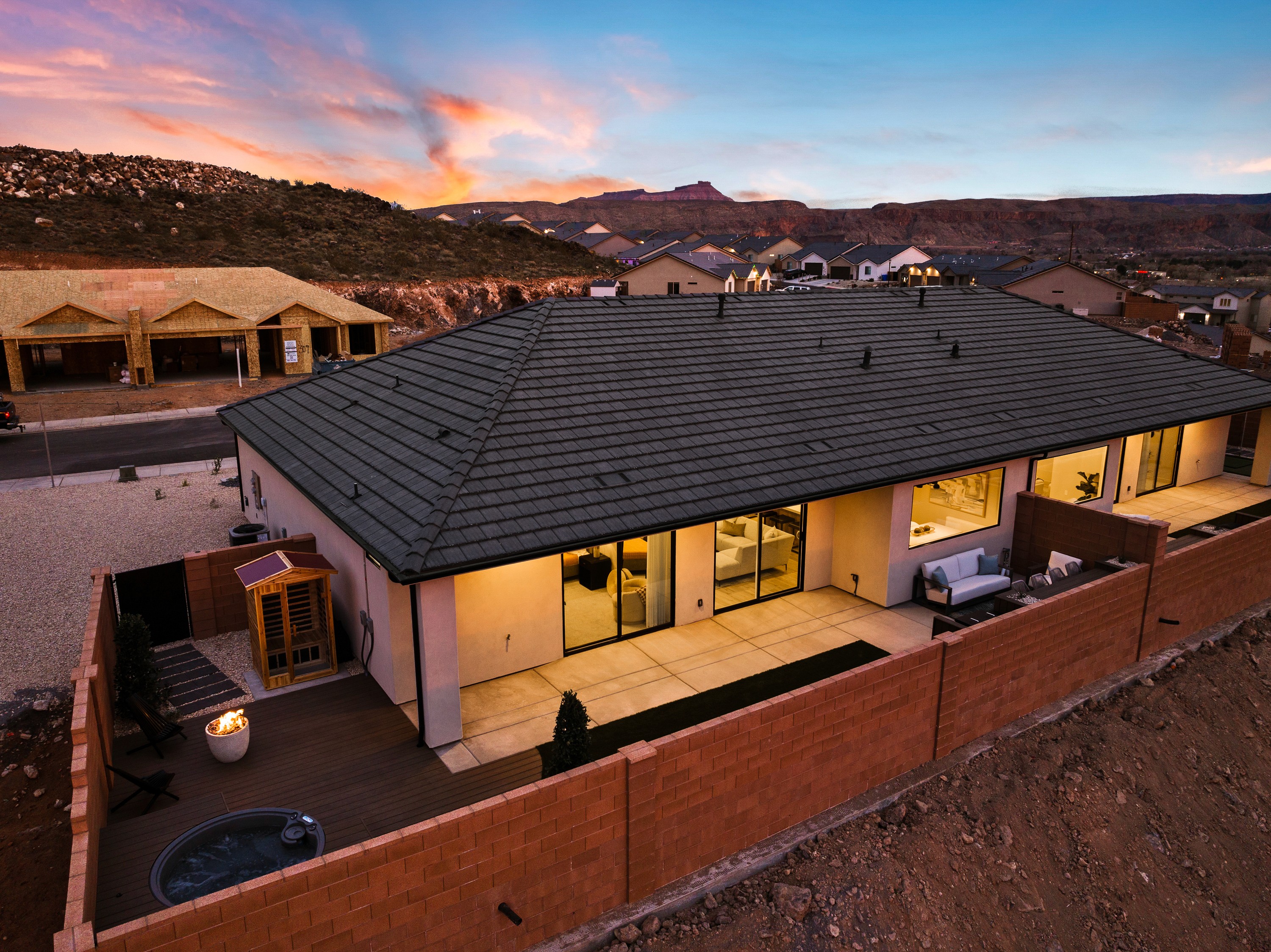 Backyard view of the BYSO House in Hurricane, Utah featuring an outdoor living area designed for entertaining.