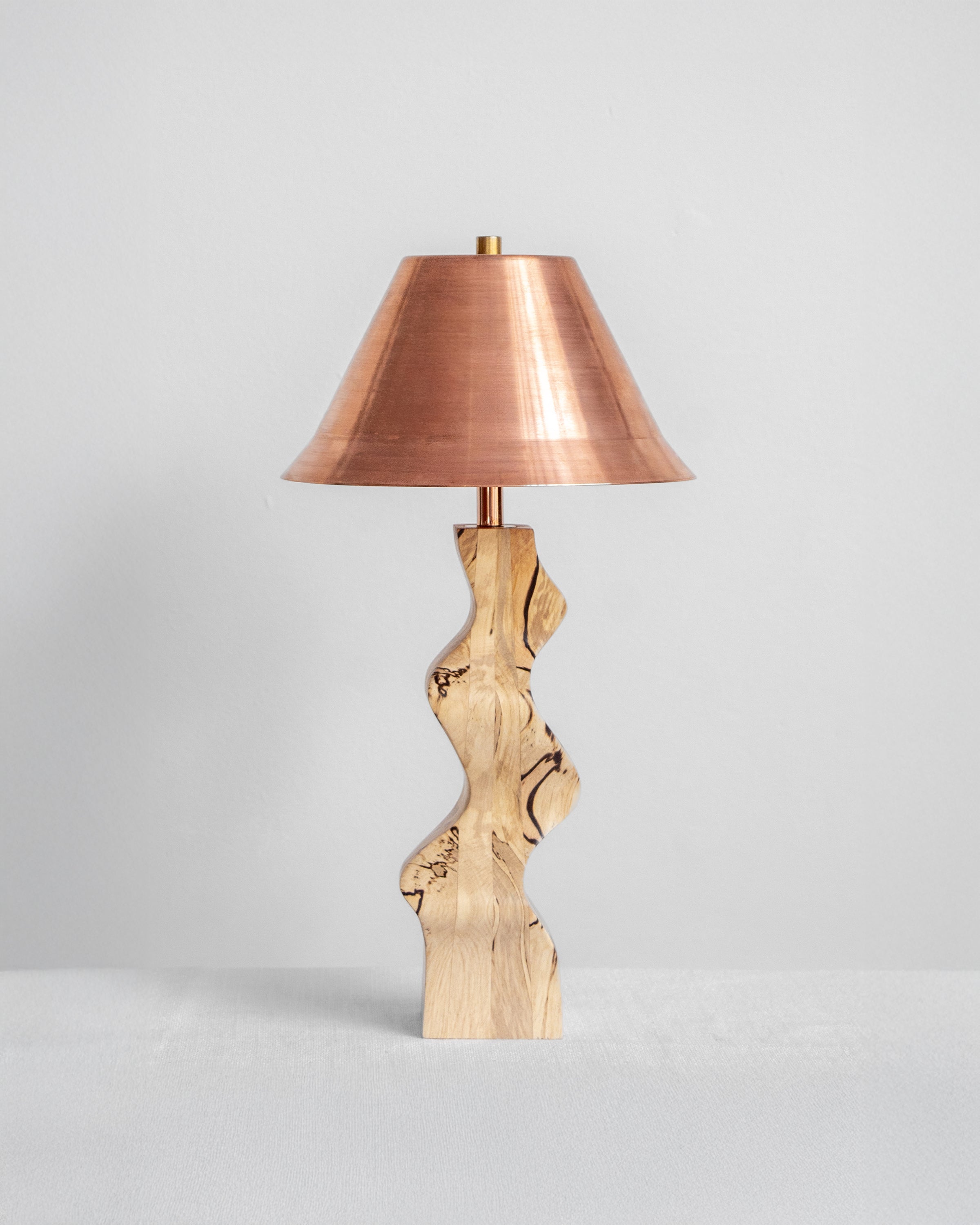 Rippled Desk Lamp with Spalted base and Copper shade on a light grey background with UK, EU and US/CA wiring available on white background Wilkinson & Rivera