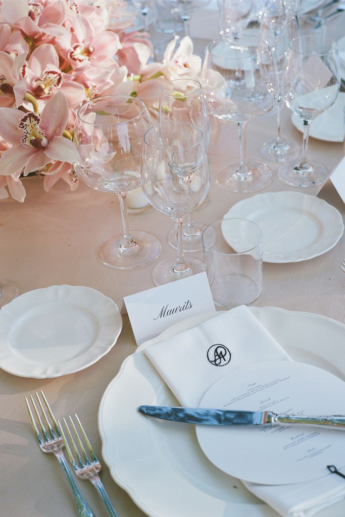 Elegant wedding table setting with monogrammed napkin, menu and blush flowers