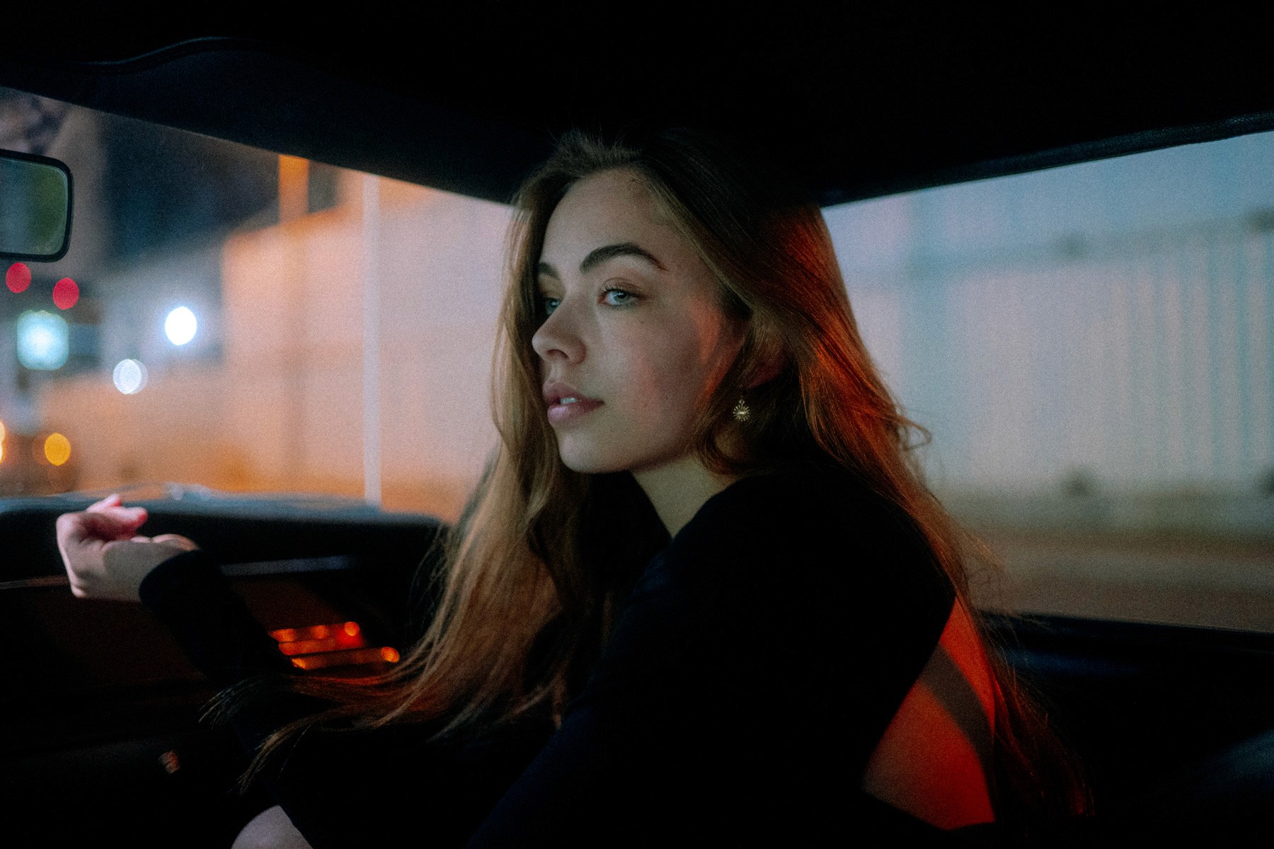 a woman holding a red flower