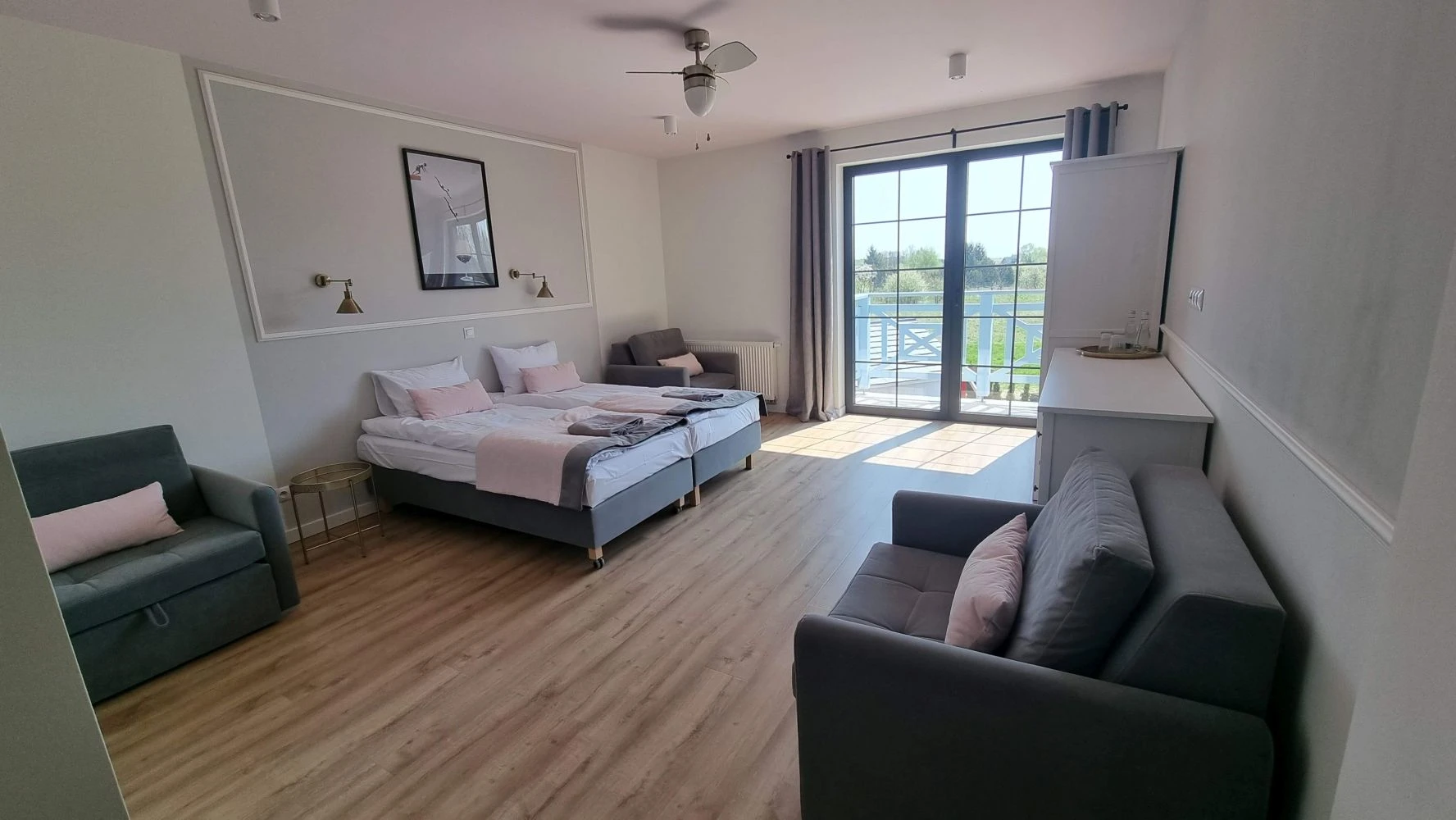 Luxury spa treatment room with a large window overlooking a lush green valley.