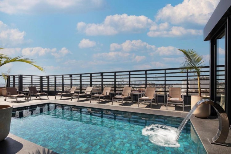 sunloungers fronting buildings near mountain