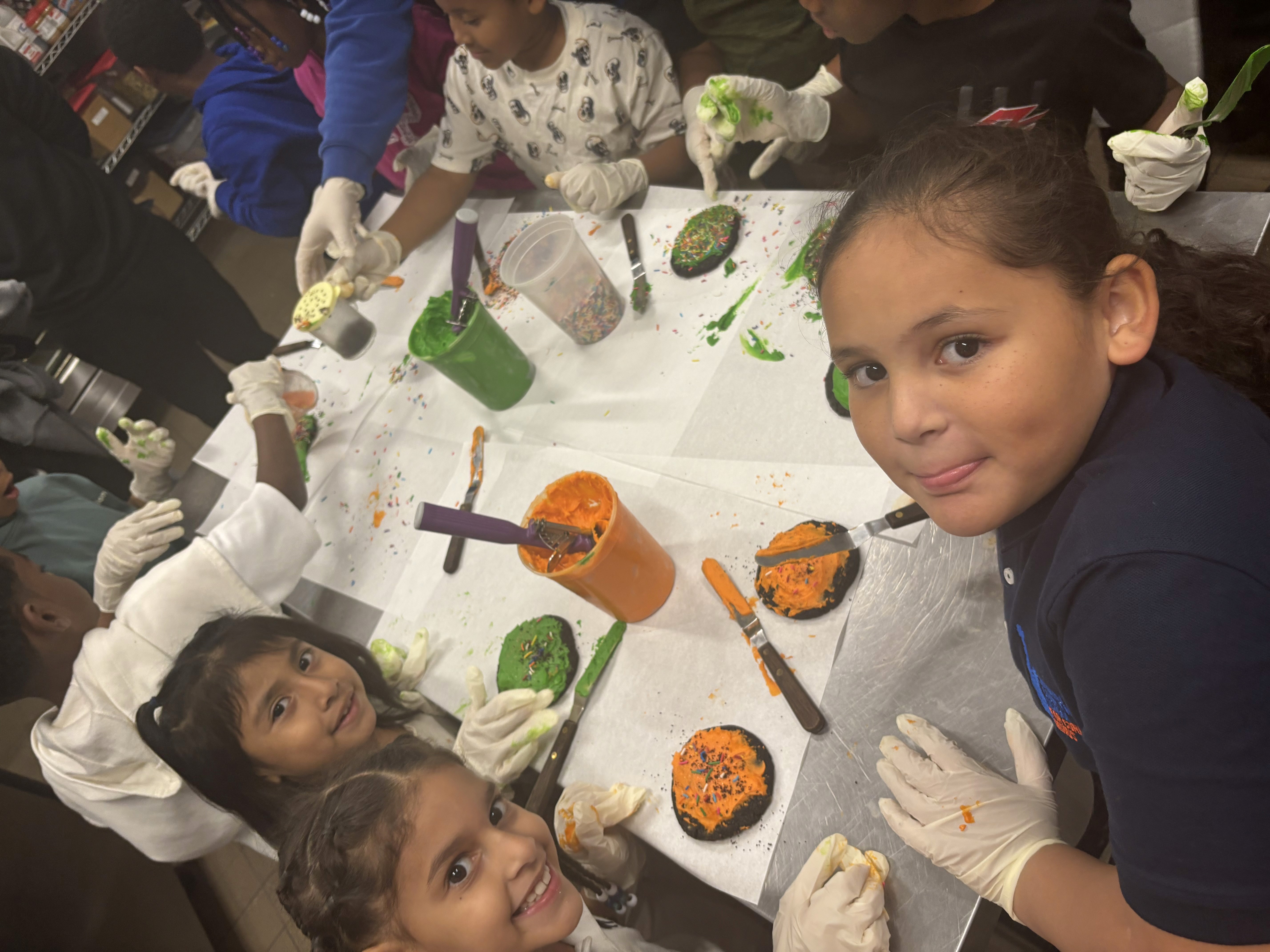 Participants decorate Halloween-themed cookies. 