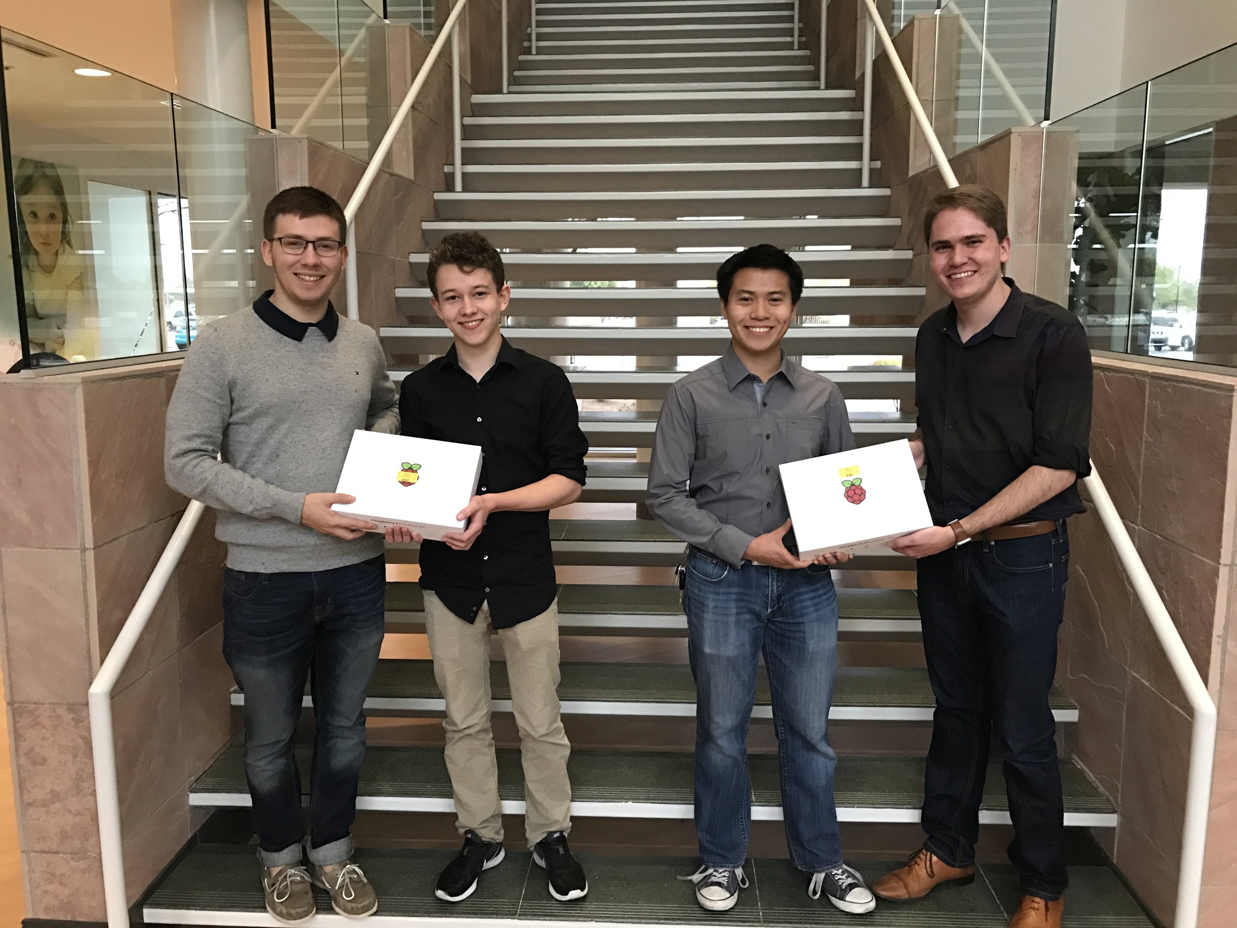 Alex accepting a hackathon prize with his teammates